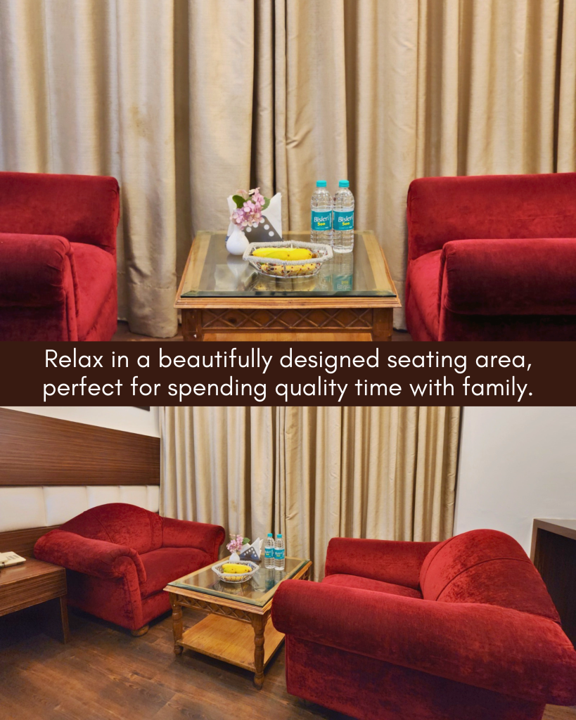 King’s Family Suite Comfortable red sofa seating area with table and refreshments inside King’s Family Suite at Hotel Surya Shimla