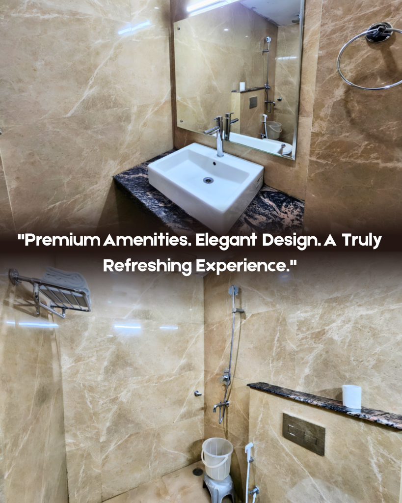 Modern luxury room bathroom at Hotel Surya Shimla featuring marble-finish walls, wash basin, large mirror, shower area and bathroom amenities