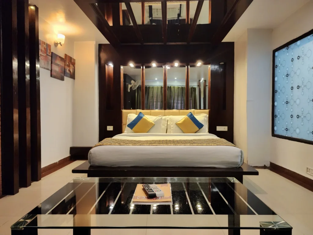 Spacious Premium Suite Room at Hotel Surya Shimla featuring a king-size bed, elegant wooden interiors, modern décor, and comfortable luxury accommodation near Mall Road.
